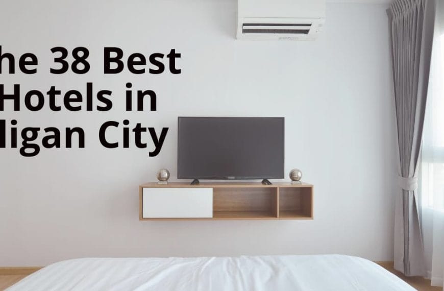 Minimalist hotel room with TV, AC, white bedding, and large window. Explore on the Iligan website for top hotels.