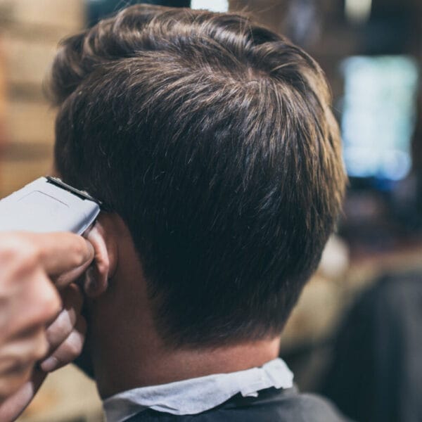 close up of a stylish haircut with clippers in an iligan barbershop, focusing on the back of the head.