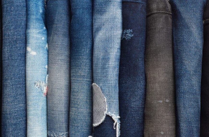 folded blue and black jeans, some distressed, neatly arranged—perfect for a thrift hunt iligan adventure.