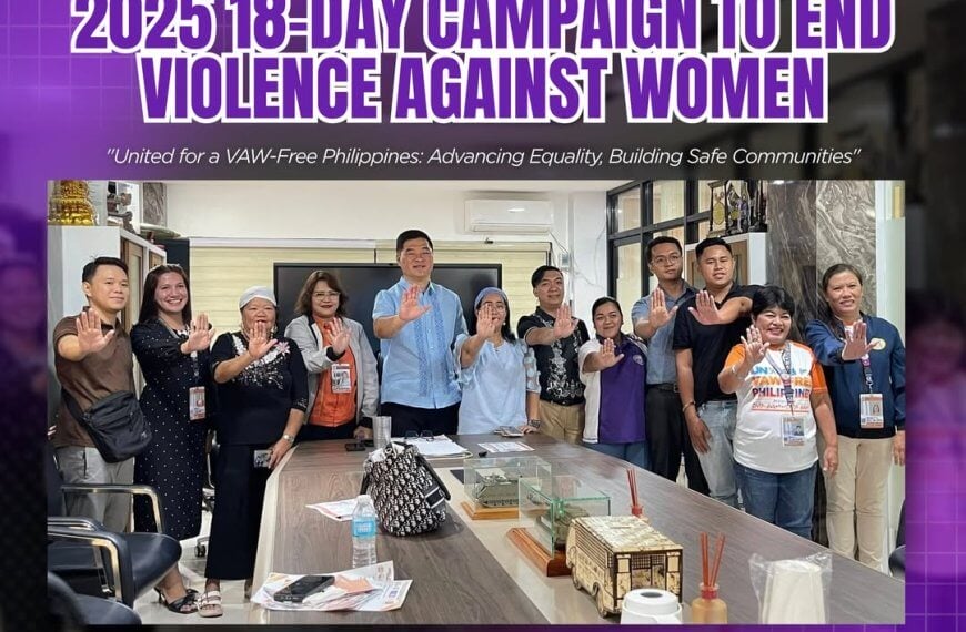 group of people in an iligan office raising hands, promoting the 2025 anti violence against women campaign.