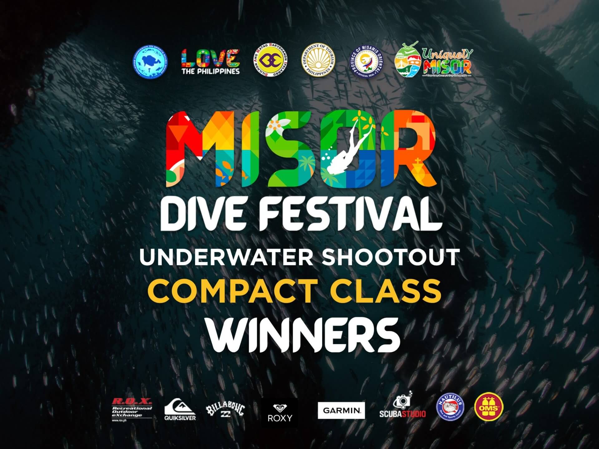 colorful misor dive festival underwater shootout compact winners text over a dark underwater fish background.
