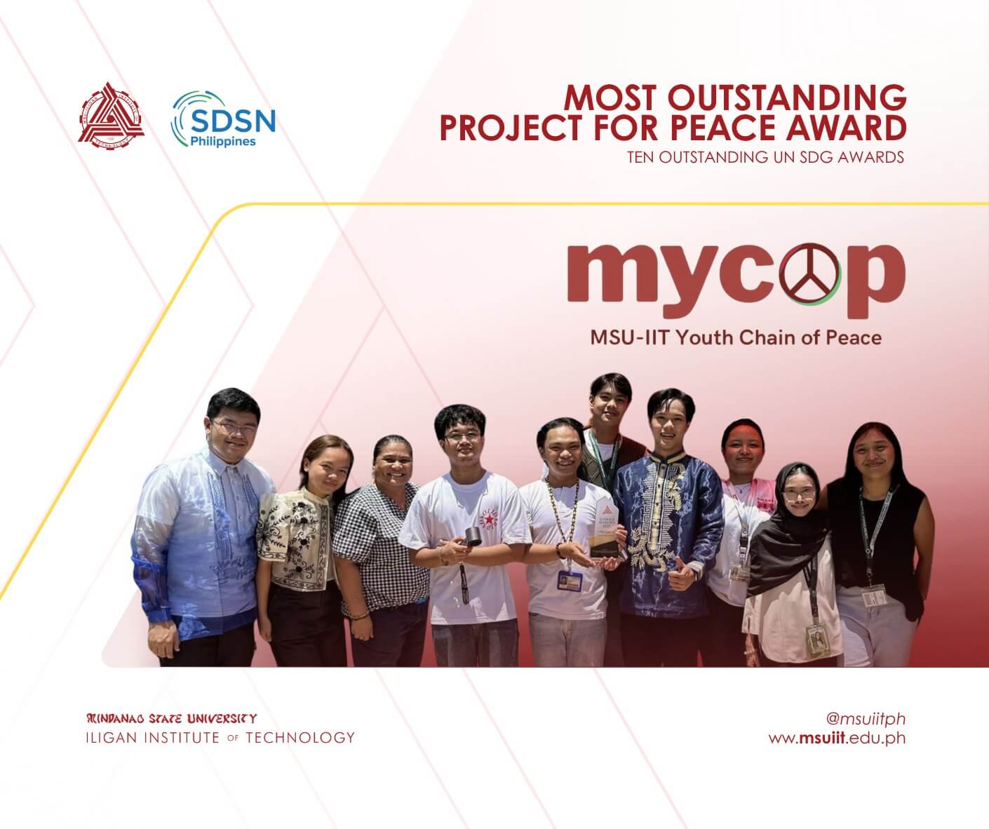 nine people stand smiling in a row, holding a certificate, beneath a most outstanding project for peace award banner.