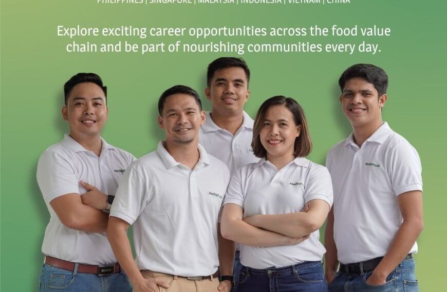 five people in white polos smile together under the aboitiz foods text, highlighting career opportunities.