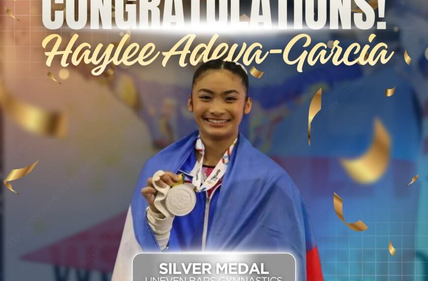 haylee adena garcia, iligan pride, smiles holding a silver medal and philippine flag at a gymnastics event.