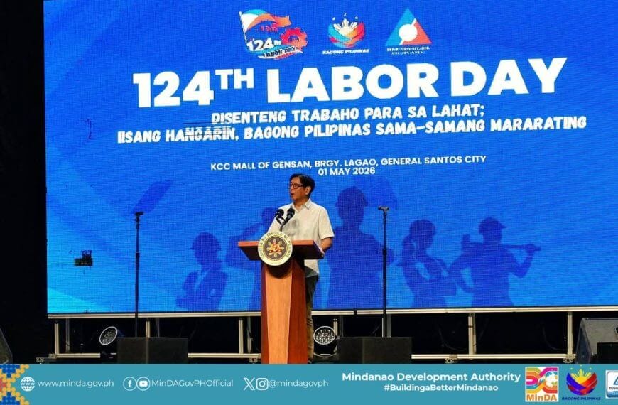 PBBM speaks at a podium before a large blue “124th mindanao labor day” event backdrop in general santos city.